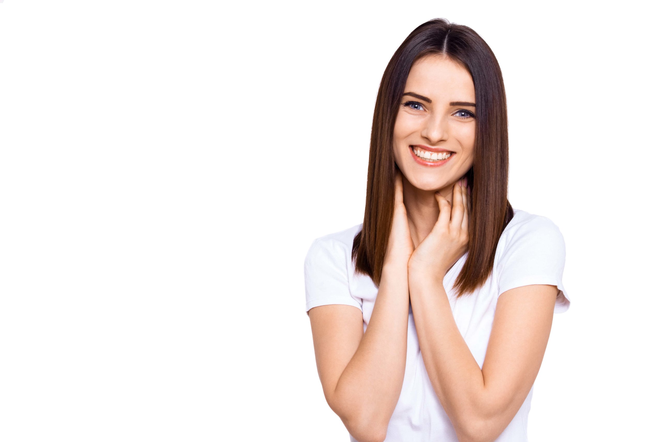 Beautiful young woman touching her neck and looking at camera with smile on face while standing against white background | Resa Medical Aesthetics in Scottsdale, AZ
