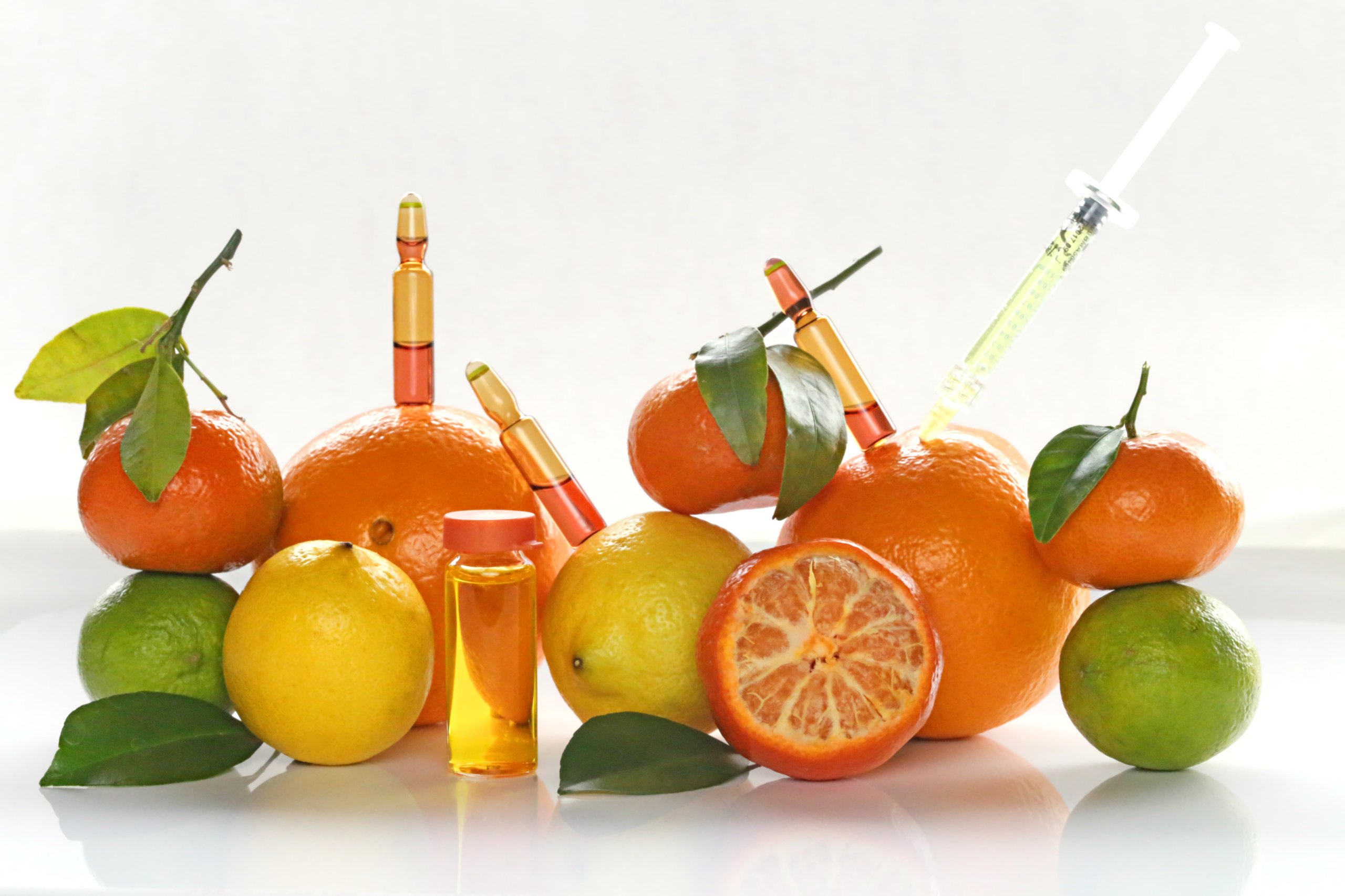 Ampoules and Serum with Vitamin C. Immunity and injection . Prevention of colds and flu.Ampoules, syringes, tangerines and oranges on a bright yellow background.Mesotherapy and rejuvenation | Resa Medical Aesthetics in Scottsdale, AZ
